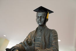 Statue wearing a graduation cap with tassel.