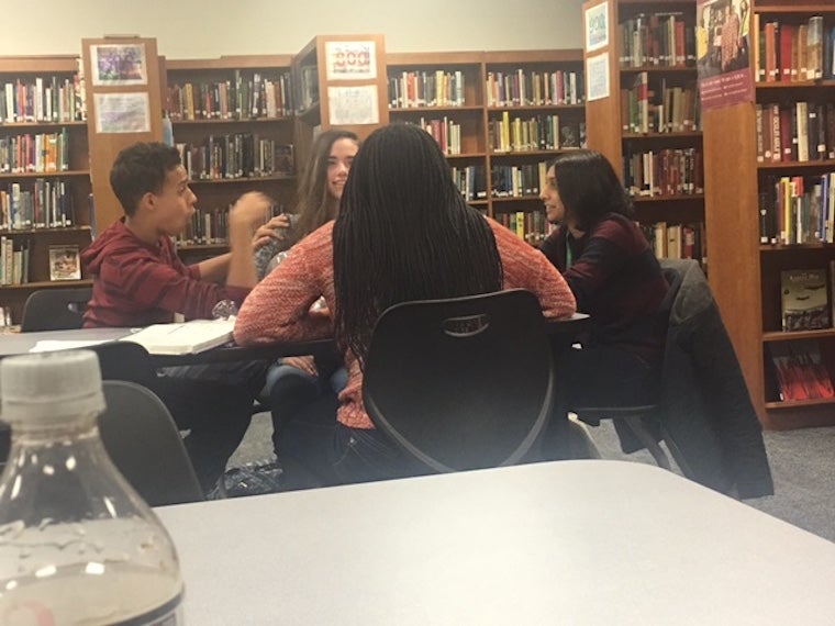 Students engaging with one another.