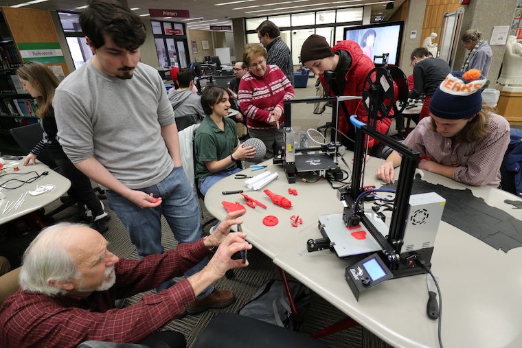 Oberlin students and community members examine 3D-printers in Terrell Main Library 