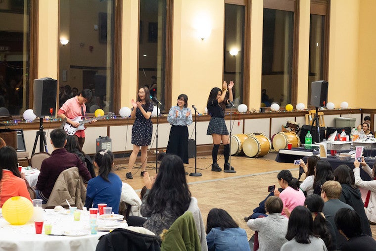students performing musical act at Asian Night Market