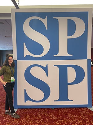 Jessia atands beside a large sign that says "SPSP"