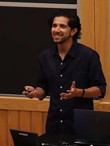 Eduardo speaking in front of a blackboard