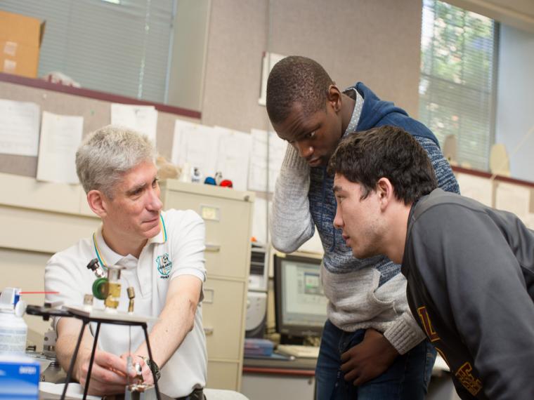 Professor Stephen Fitzgerald talks with some students in his lab.