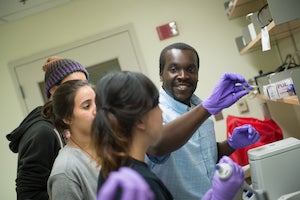 Professor Gunnar Kwakye teaching students in his lab.