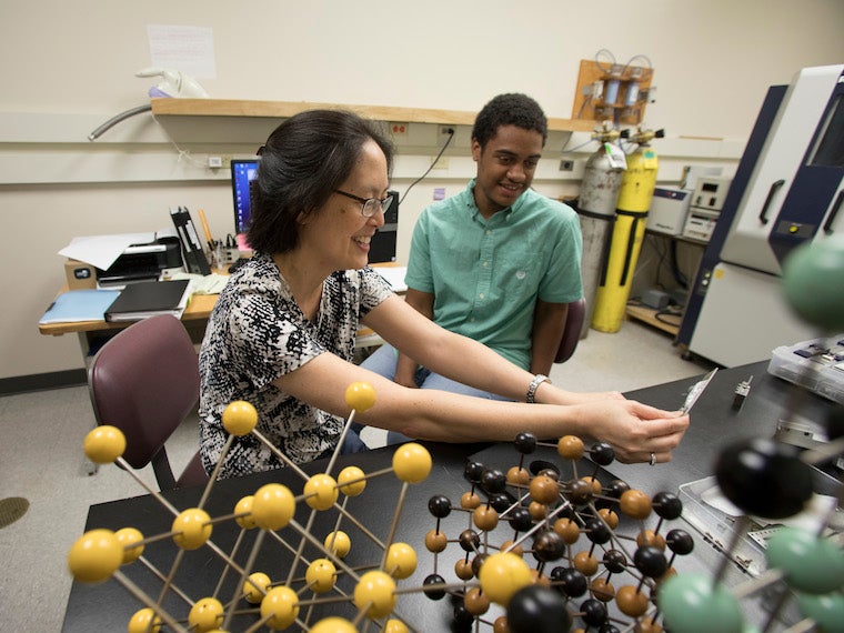Professor Yumi Ijiri interacting with students in her lab.