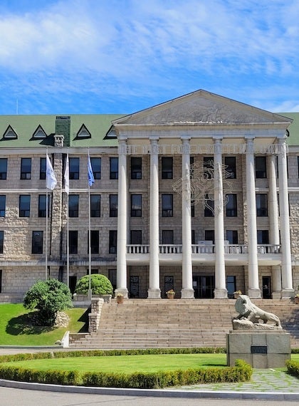 Hanyang University main administrative building in front of a blue sky filled with clouds.