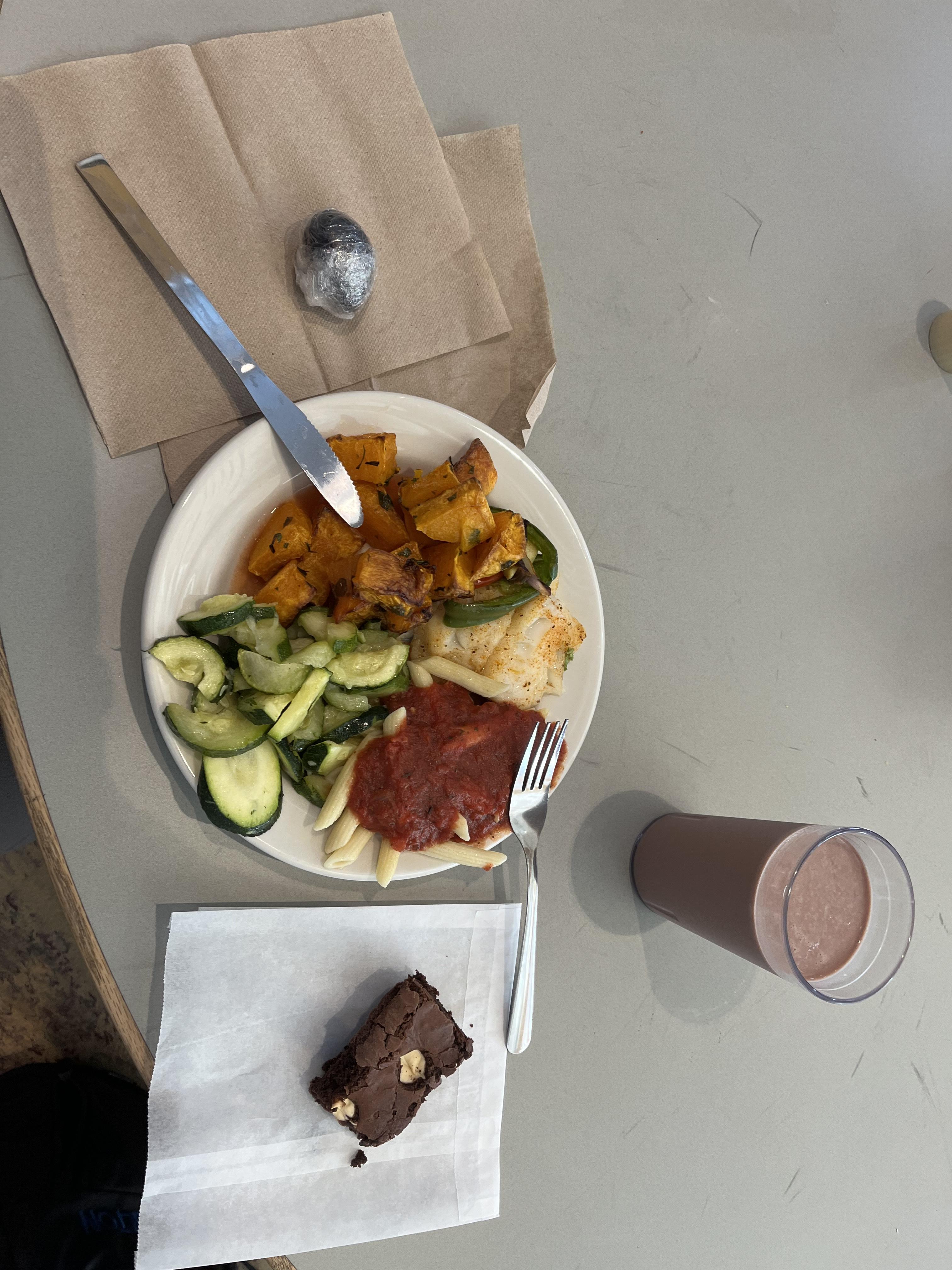 A meal from Stevenson Dining Hall with chocolate milk and a brownie on a table.