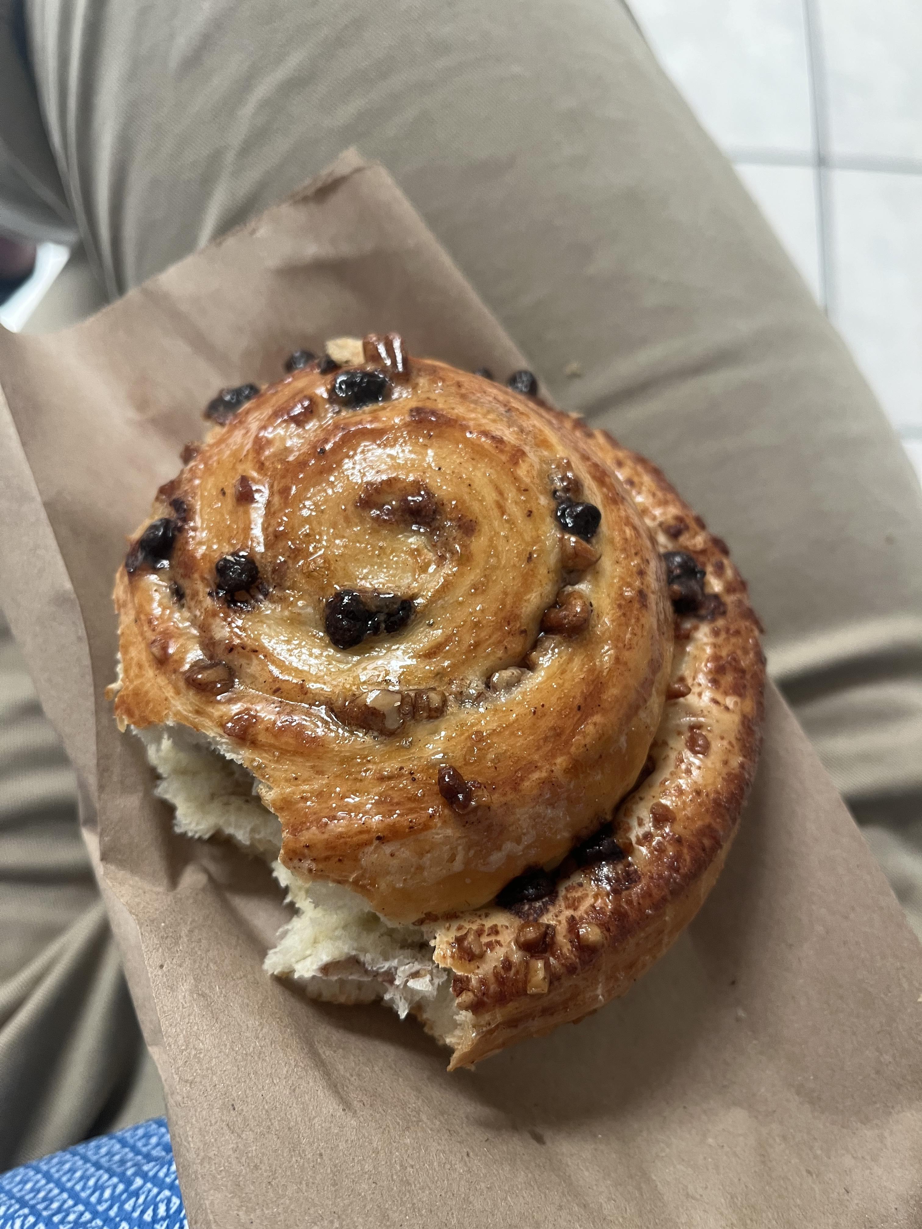 A swirled cinnamon roll with raisins