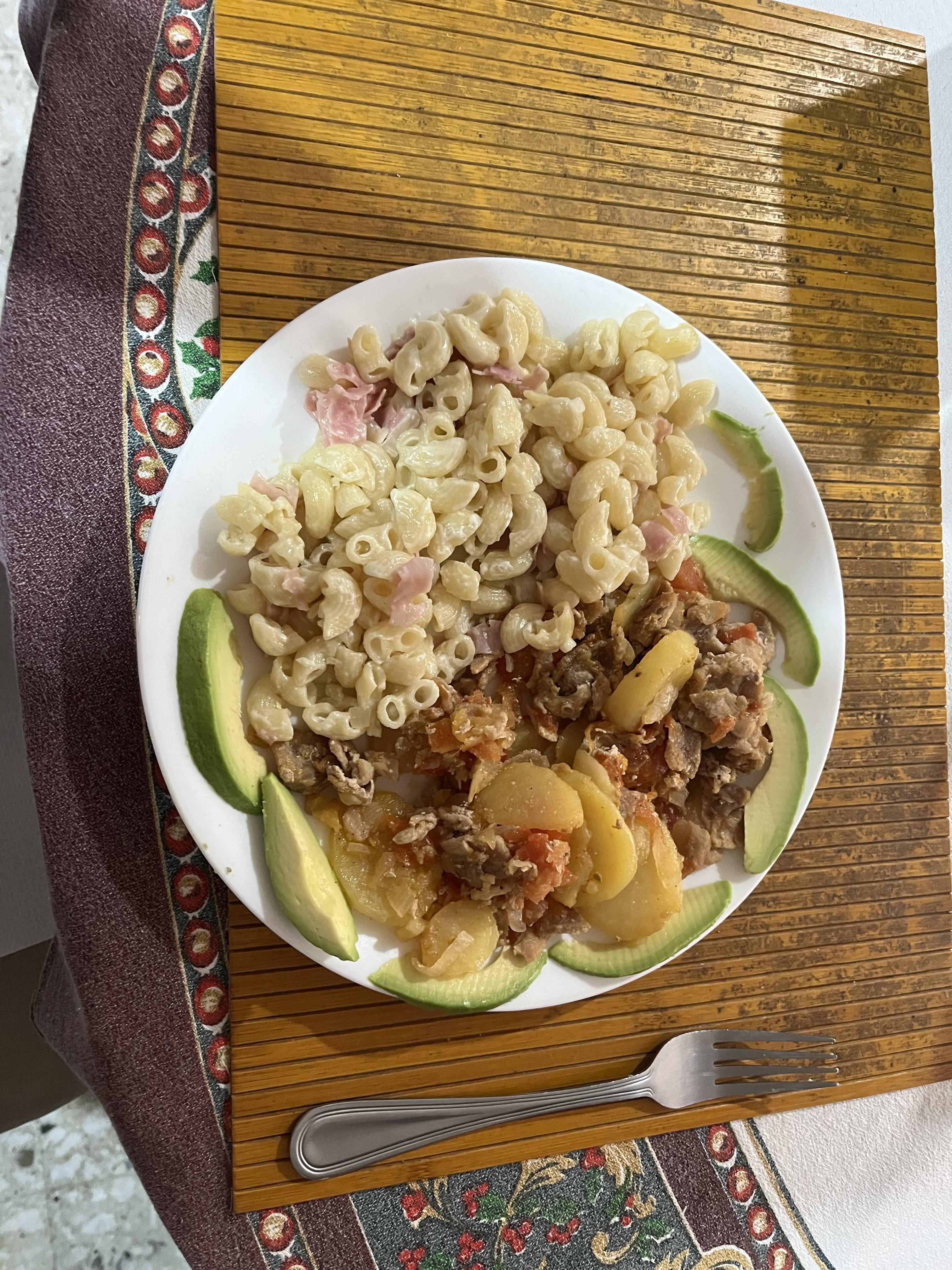 A meal of pasta, minced beef, and avocado.