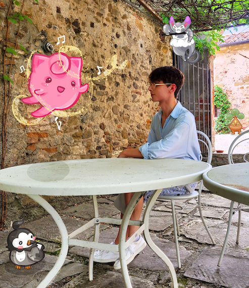 Me sat at a table with digitally illustrated Pokémon around me.