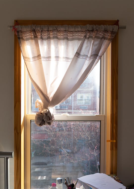 A curtain in a lit room.