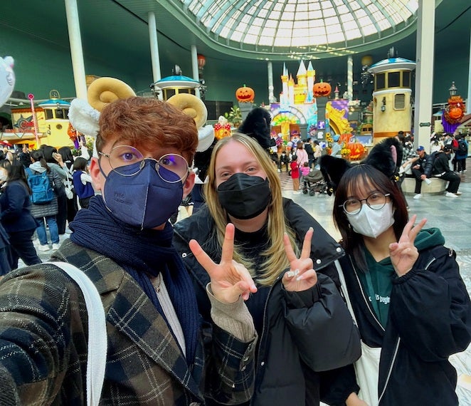 A selfie with two friends at Lotte World in which we are all wearing animal headbands and doing peace-signs.