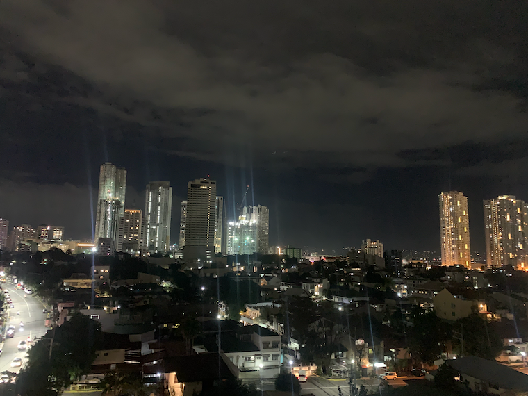 a city is lit up by lights at night