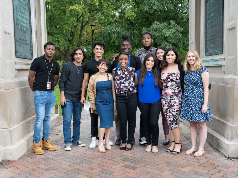 A group of ten students and a staff member pose for a photo.