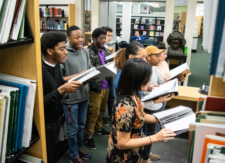 A small student choir performs.