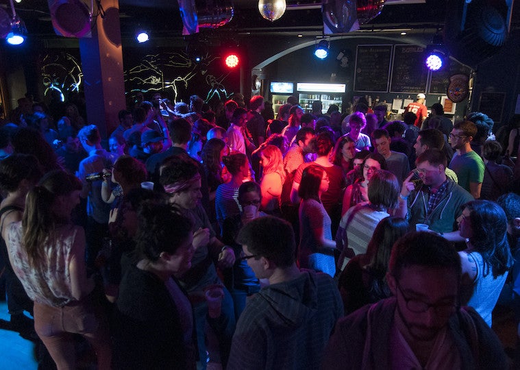 People dancing in a dark nightclub.
