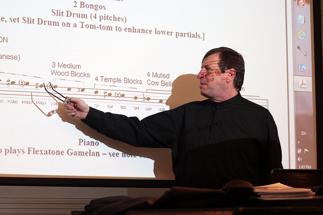 Professor points at text on a whiteboard