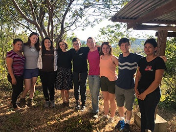 A group of students in a wooded area.