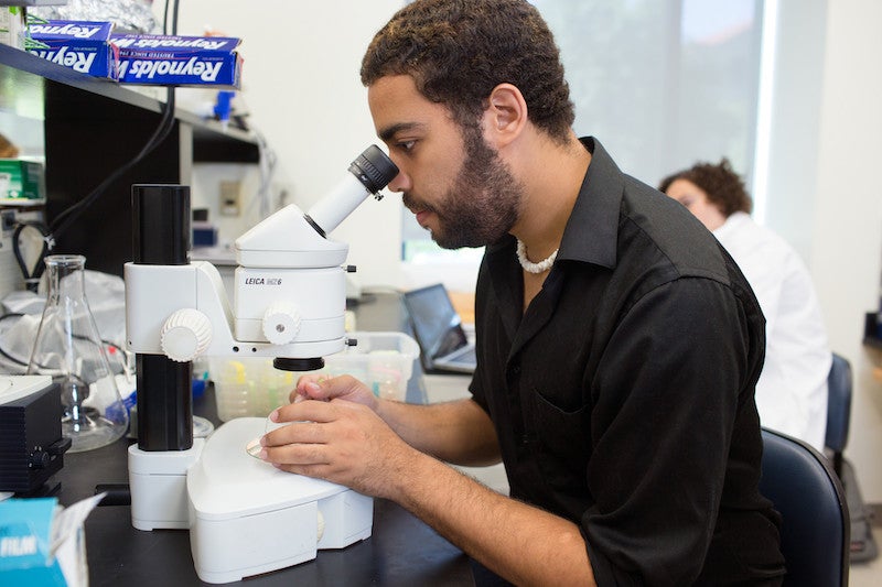 Gaybe Moore with microscope.