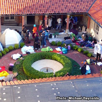 Students wait outside the museum, some in tents and sleeping bags.