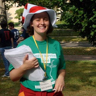 Francesca hand out information while wearing a Day of Service 2008 tee shirt