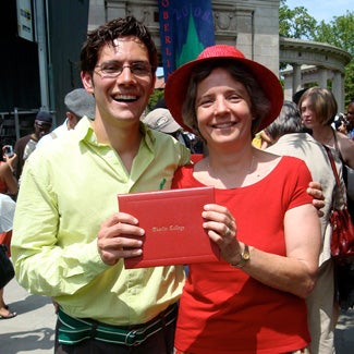 Jill and her son hold up an Oberlin College degree