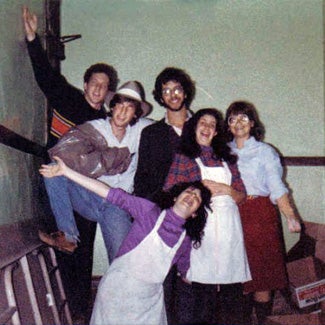 Group of jubilant students, some wearing aprons