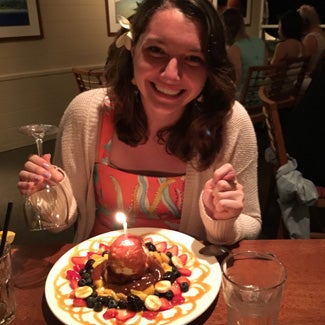 Megan's elegant dessert has a lit candle at the center.