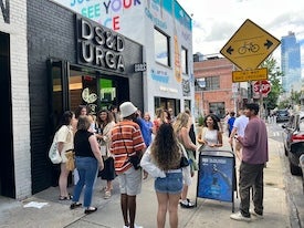 People gather outside store.