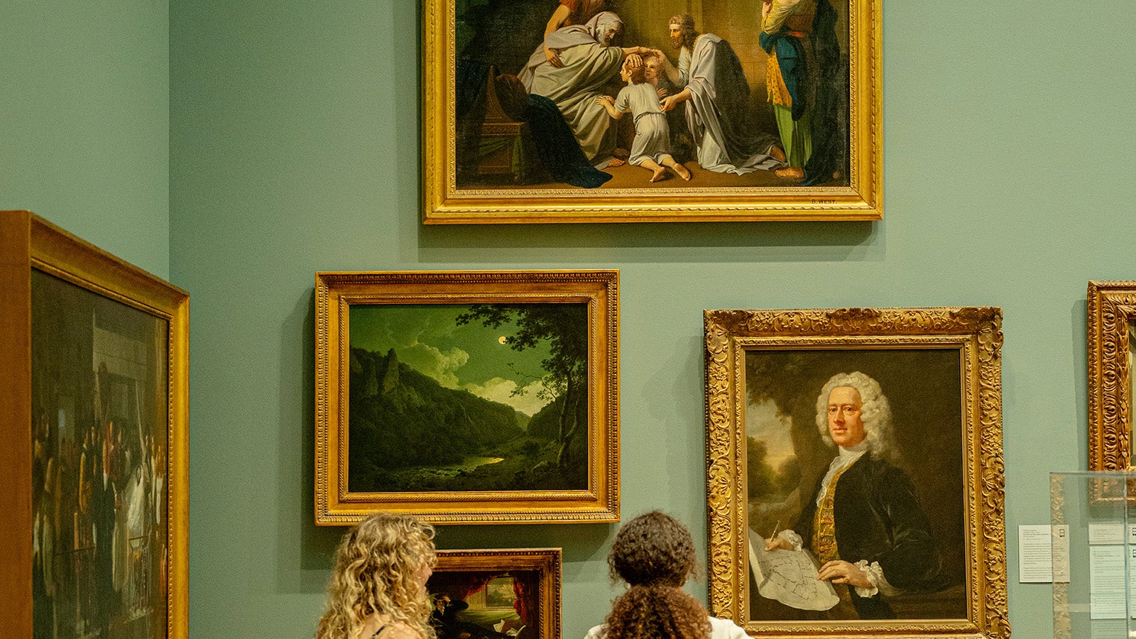 Students look at Renaissance paintings hanging in the museum.
