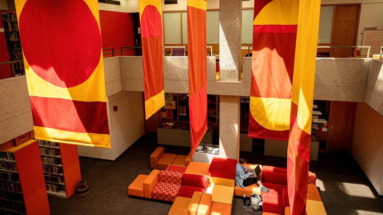 Atrium of the library, with brightly colored banners hanging from the ceiling.