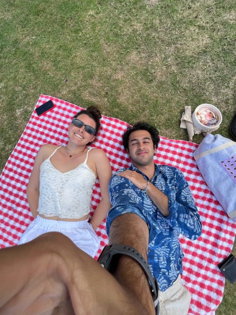 Aahil taking a selfie with Ava on a picnic blanket
