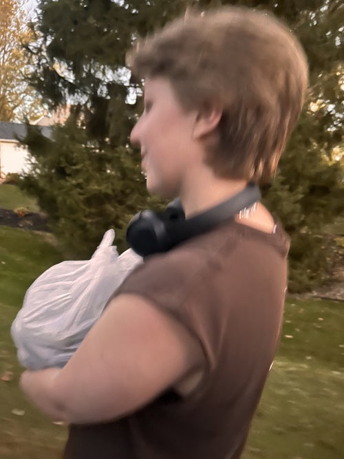 Hanna carrying a bag of black walnuts