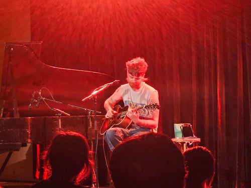 Field Medic performing at The Cat in the Cream, singing and playing guitar.