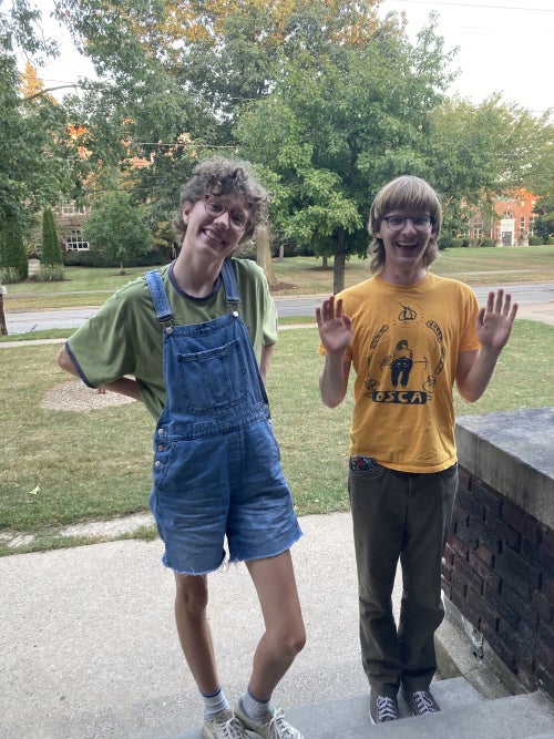 Eric waving and smiling next to Dezzie