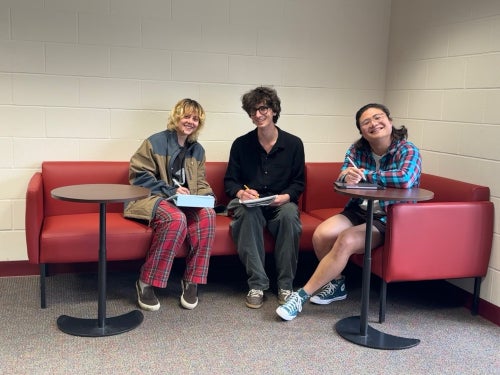 Three students sitting in Math Library