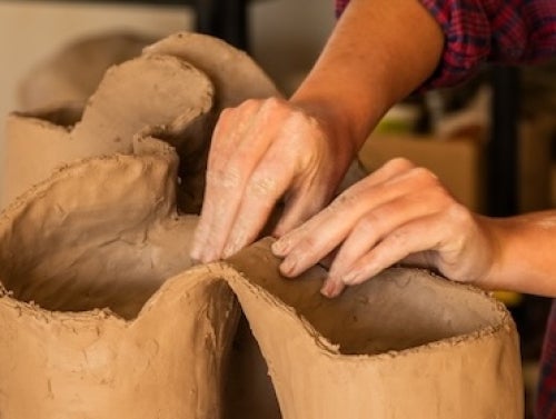 student with clay