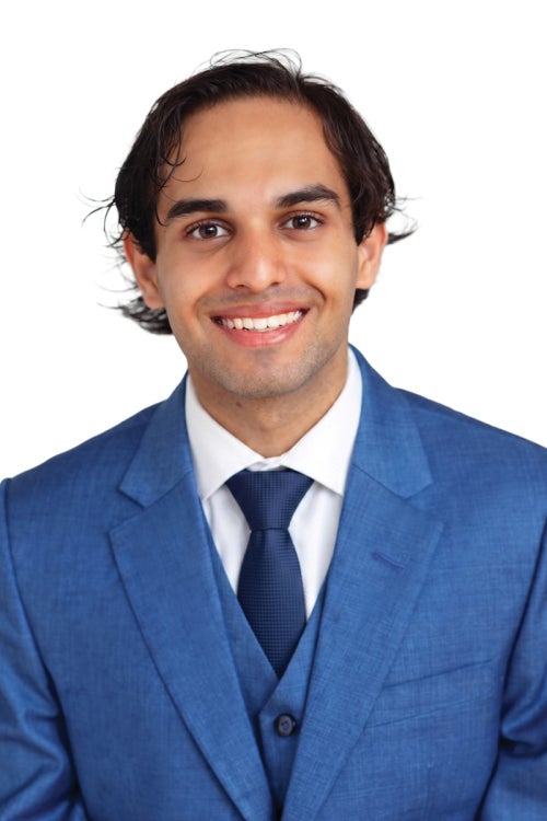 a person wearing a blue suit and a navy blue tie