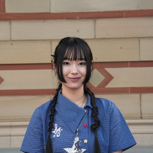 A headshot of a female student with long black hair.