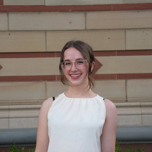 A headshot of a female student in a white shirt.