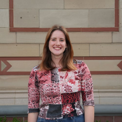 A headshot of a female student in a red shirt.