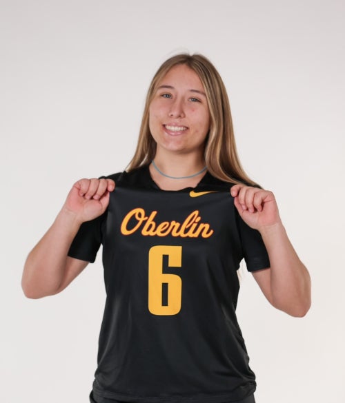 Kylie Thompson smiling in Oberlin Women's Lacrosse uniform.