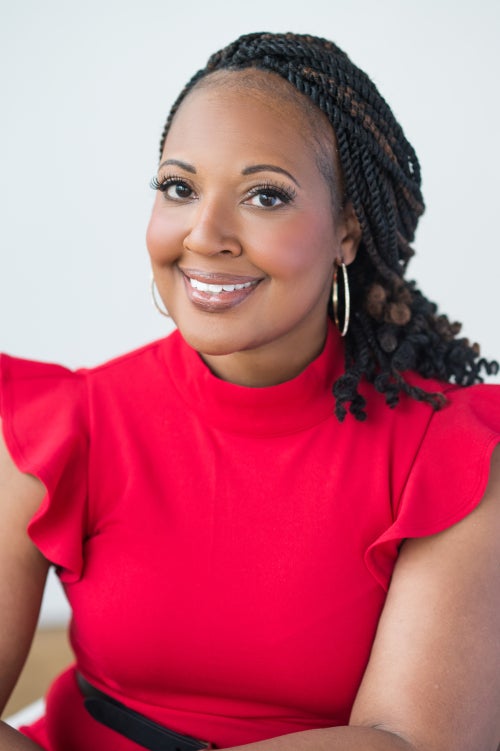 A professional photo of JeffriAnne WIlder, Ph.D. The photo is from the waist up and she is wearing a red top.