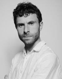 black and white photo of man with dark hair and beard