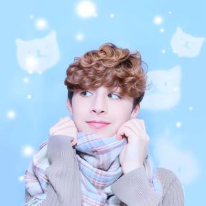 Headshot of me wearing a large striped scarf in front of a pastel blue background.