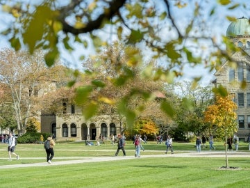 Fall trees with students walking in Wilder Bowl