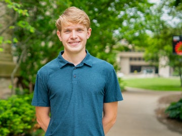Student smiles on campus