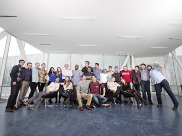 Group of students and alumni posing together indoors at the LaunchU program.