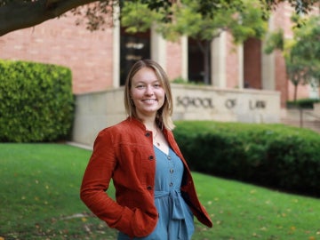 a person stands in front of law school