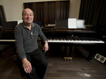 Dan Wall seated at two pianos.